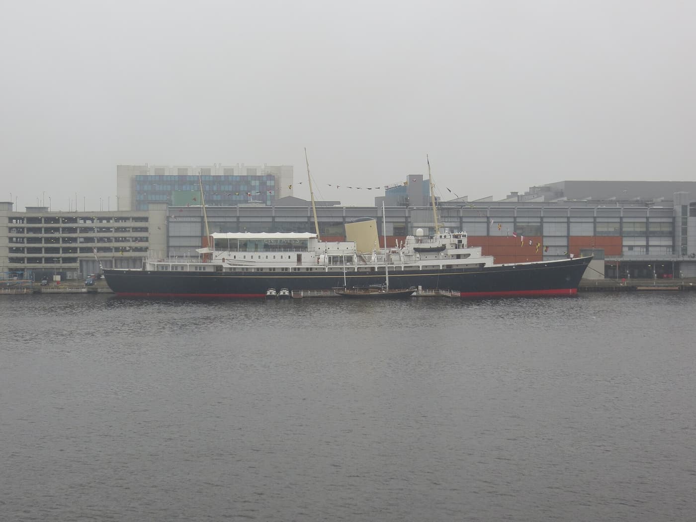 The Royal Yacht Britannia moored at Leith docks on a grey day