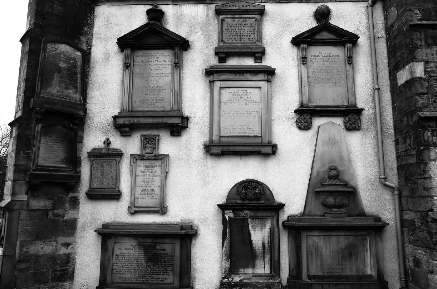 Weathered stone memorials on a wall in Greyfriars Kirkyard, Edinburgh