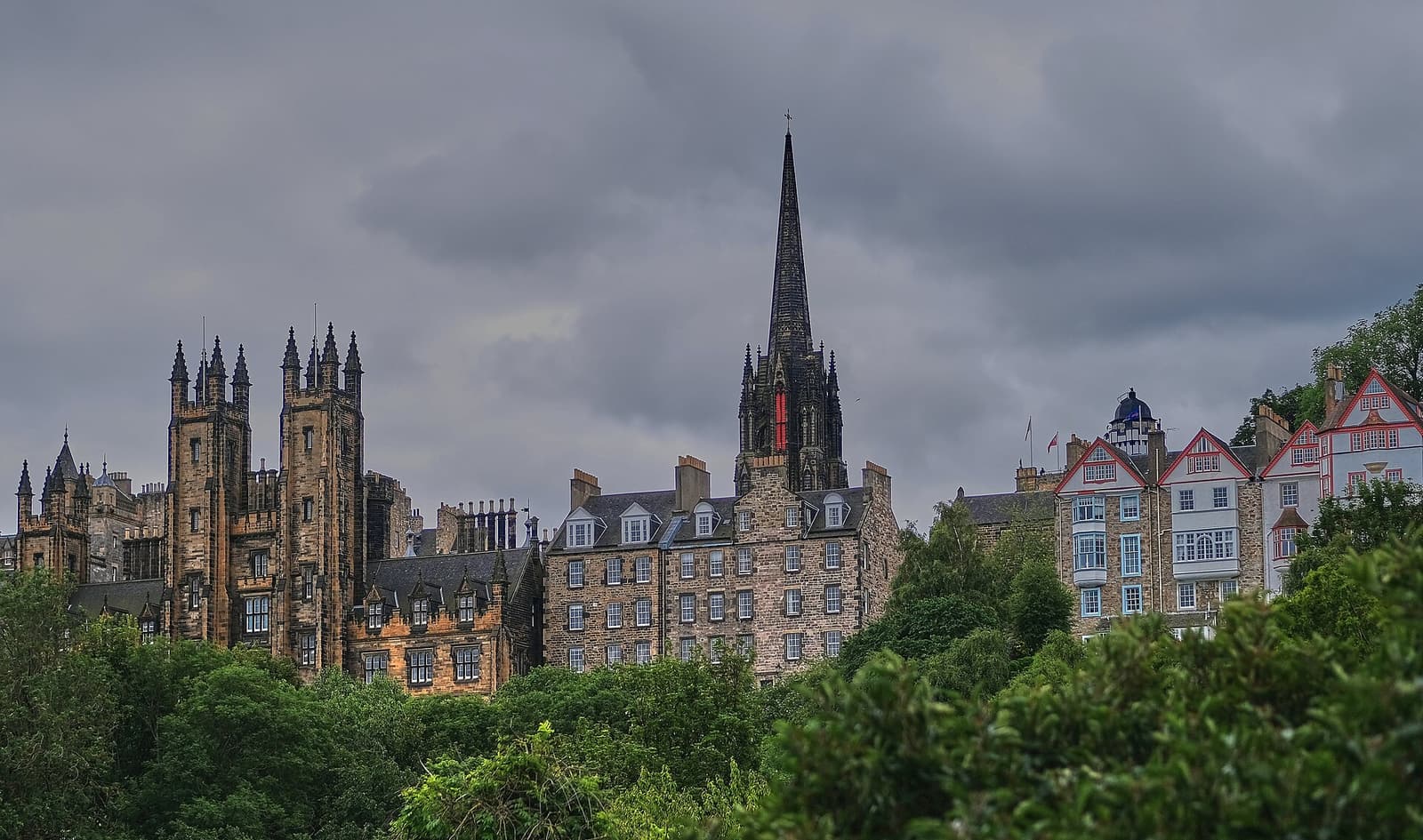 The towers and spires of Edinburgh’s Old Town skyline rising above trees
