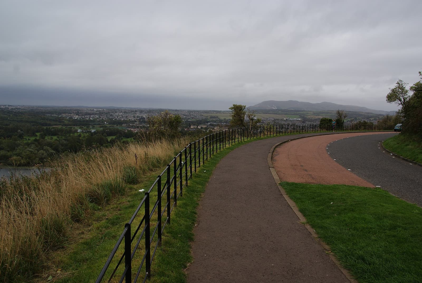 Queen’s Drive curving through Holyrood Park beside a footpath and railings