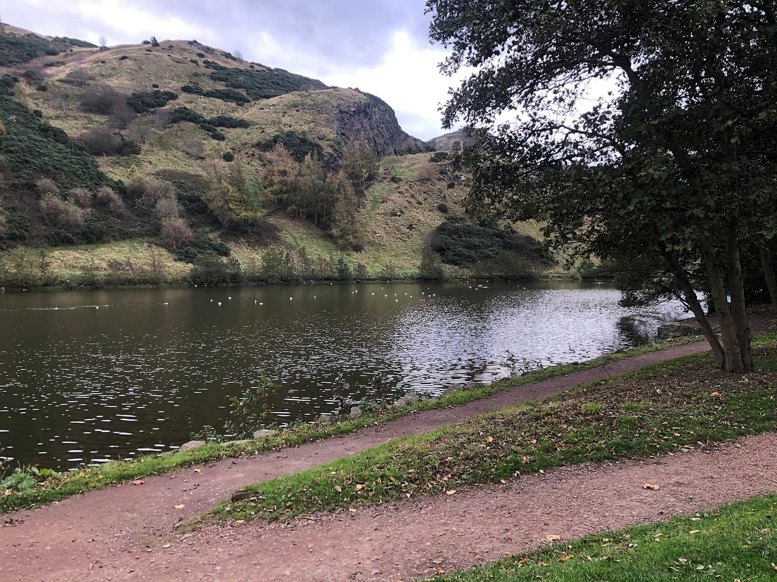 St Margaret’s Loch and its lakeside path, with the slopes of Holyrood Park rising behind